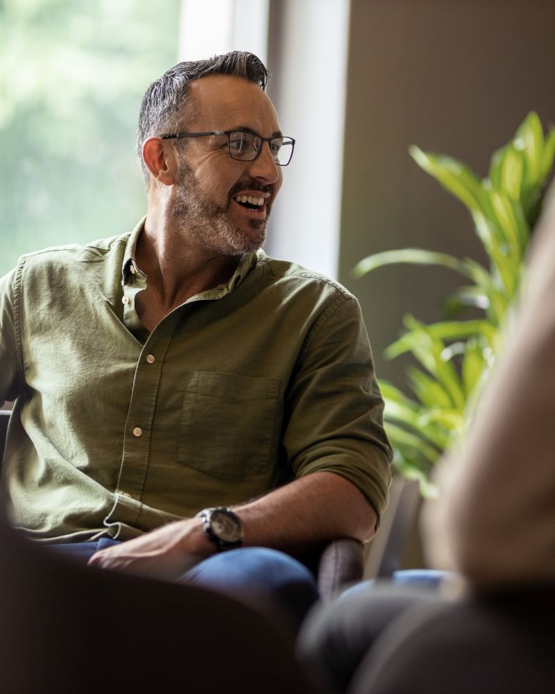 a happy person talking to someone out of shot